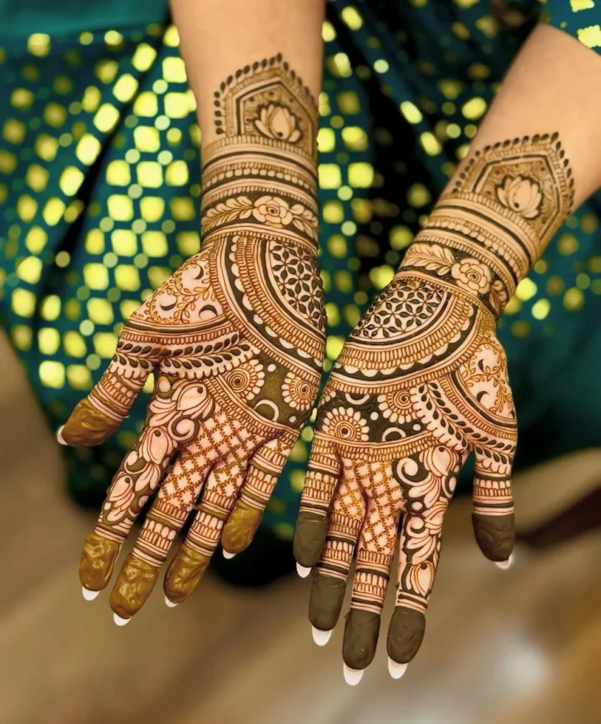 Beautiful lotus-themed mehndi design with ornate mandalas, geometric grids, and floral accents covering the palms and wrists